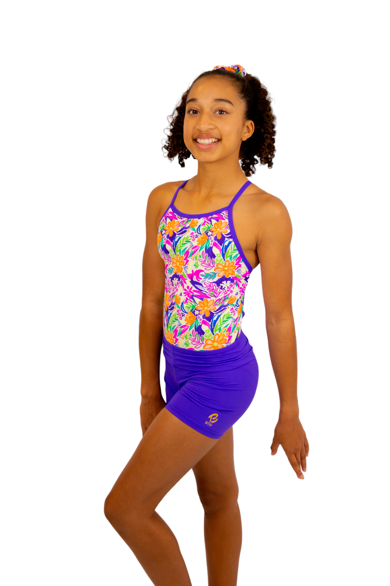 Bright Coloured Tropical Print One Piece Leotard or Swimsuit for Girls. Gymnastics Leotard, Girls Swimwear, Strappy Back, Racer Back, Tank Style, Thin Straps all Available. Fluorescent Purple, green, Yellow, Orange Flowers. Matching Scrunchie and Bike Shorts. B you Active, B you Leotards, B you Swimwear.