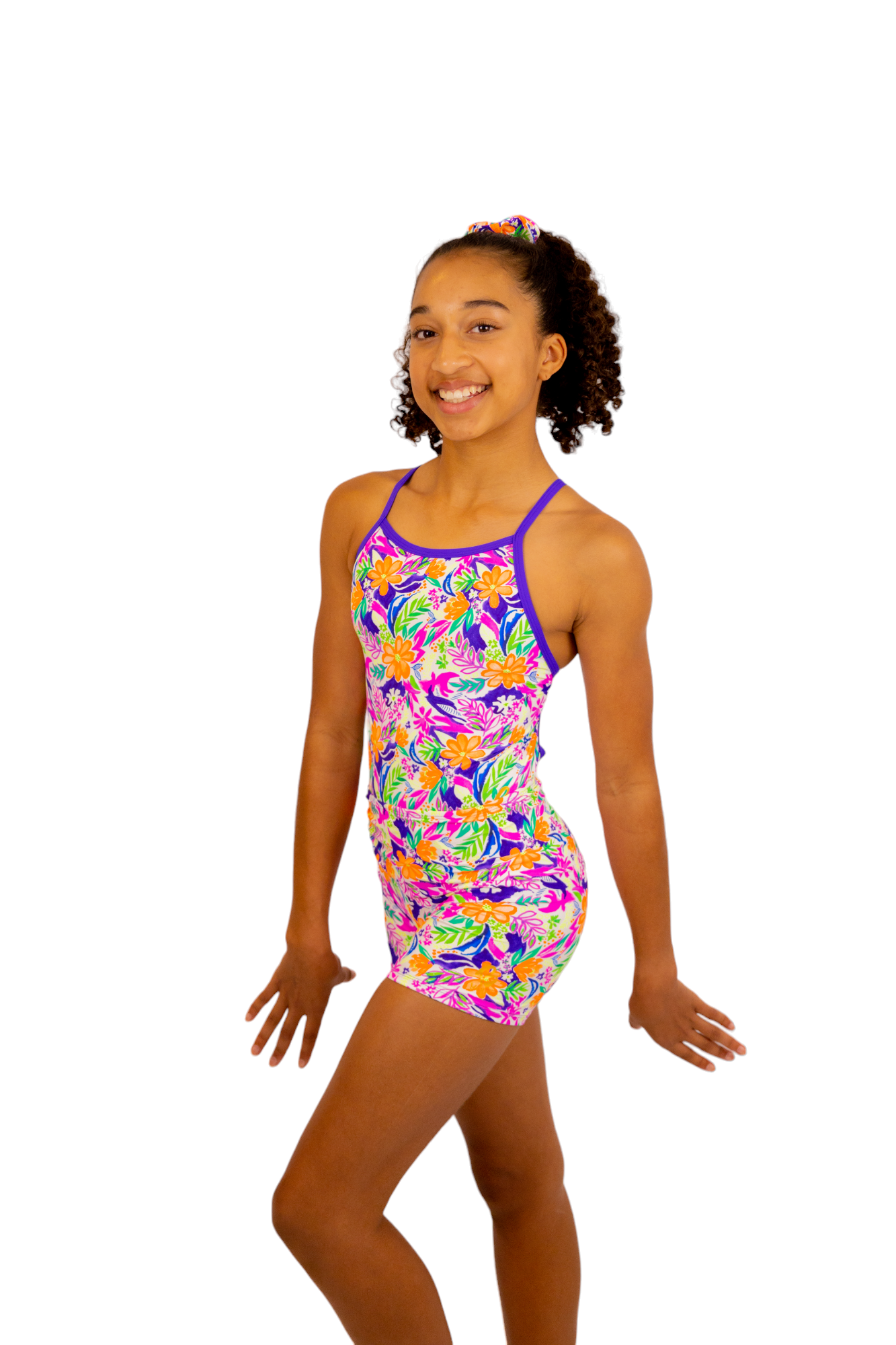 Bright Coloured Tropical Print One Piece Leotard or Swimsuit for Girls. Gymnastics Leotard, Girls Swimwear, Strappy Back, Racer Back, Tank Style, Thin Straps all Available. Fluorescent Purple, green, Yellow, Orange Flowers. Matching Scrunchie and Bike Shorts. B you Active, B you Leotards, B you Swimwear.