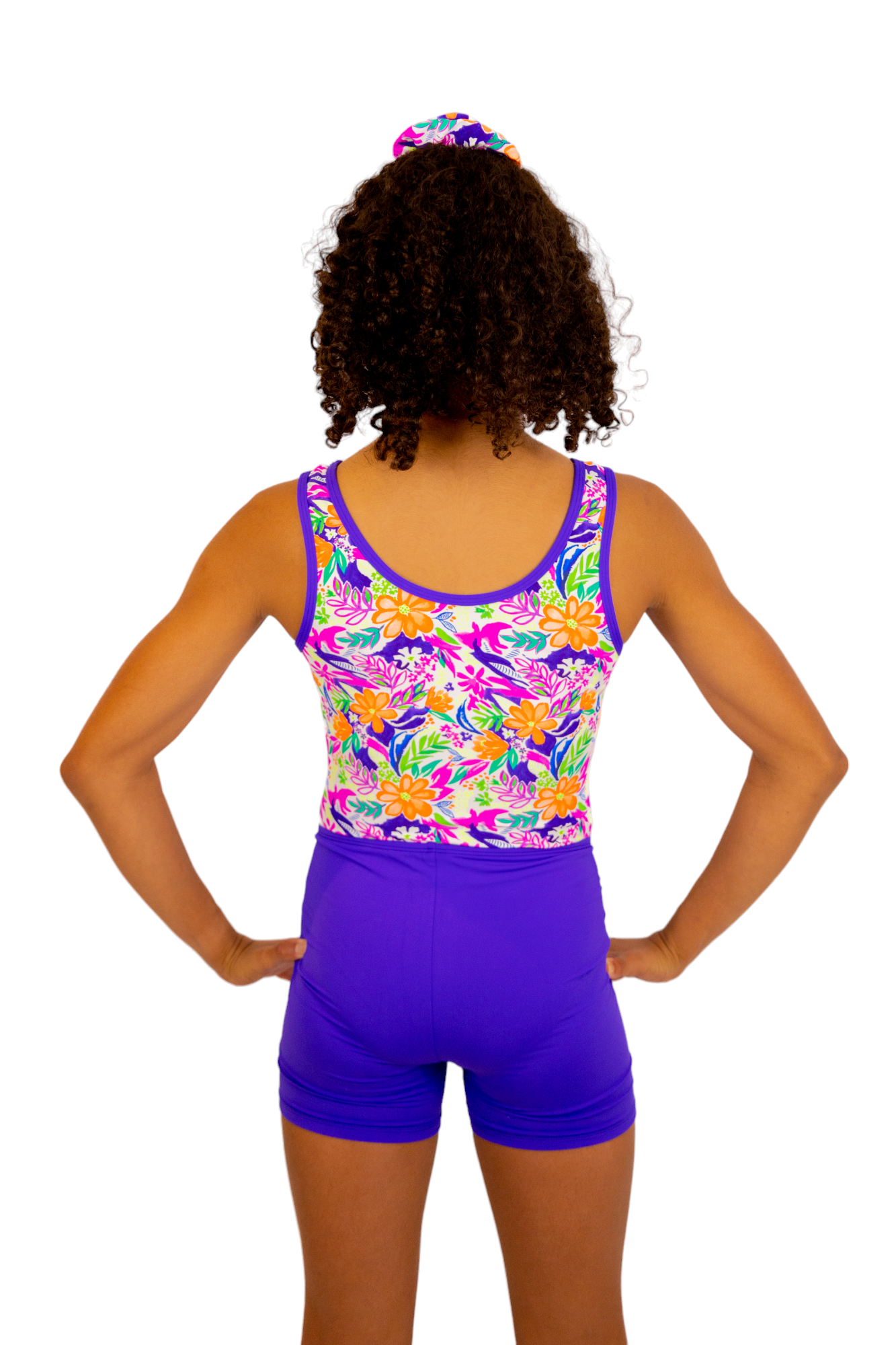 Bright Coloured Tropical Print One Piece Leotard or Swimsuit for Girls. Gymnastics Leotard, Girls Swimwear, Strappy Back, Racer Back, Tank Style, Thin Straps all Available. Fluorescent Purple, green, Yellow, Orange Flowers. Matching Scrunchie and Bike Shorts. B you Active, B you Leotards, B you Swimwear.