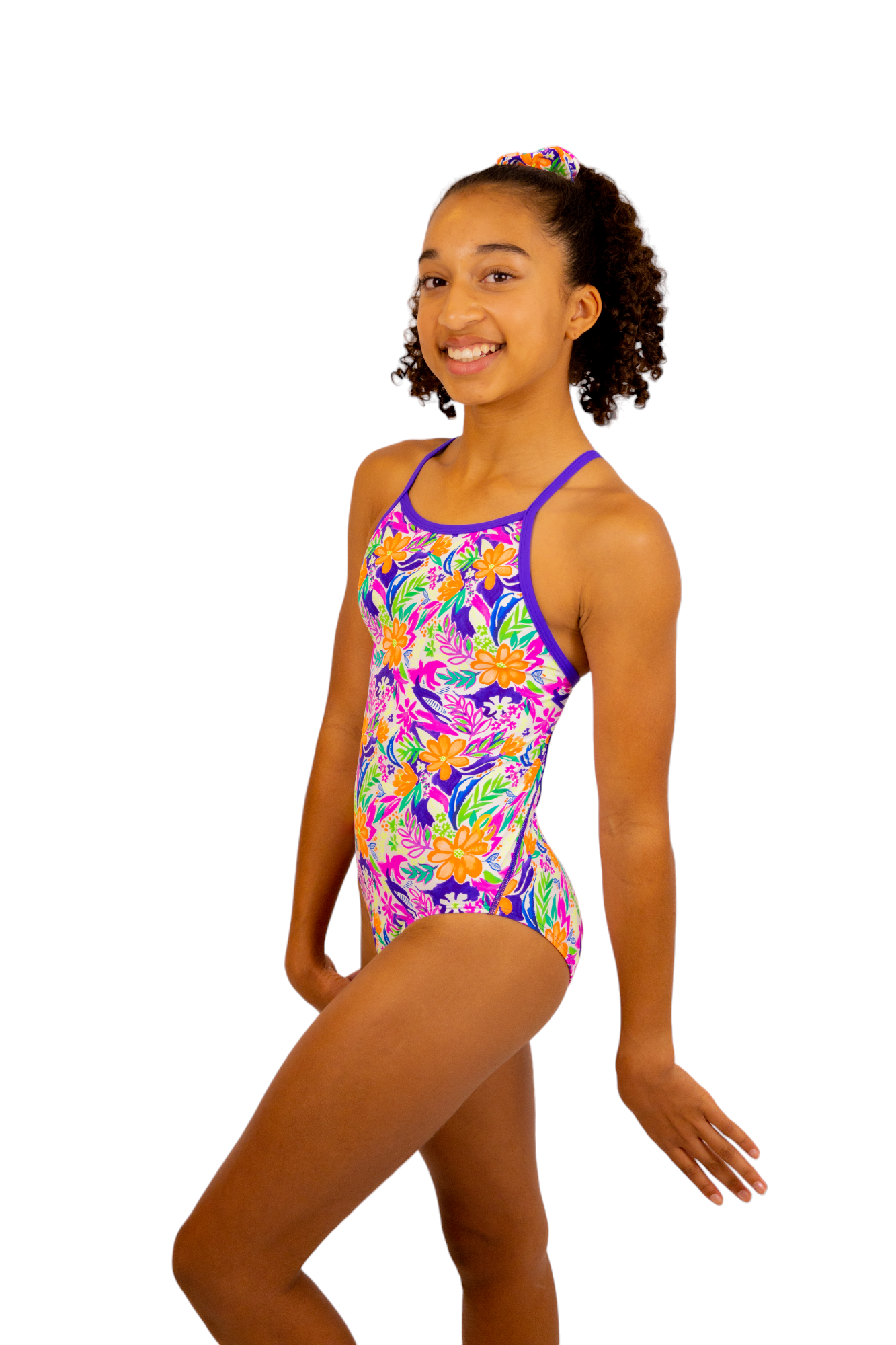 Bright Coloured Tropical Print One Piece Leotard or Swimsuit for Girls. Gymnastics Leotard, Girls Swimwear, Strappy Back, Racer Back, Tank Style, Thin Straps all Available. Fluorescent Purple, green, Yellow, Orange Flowers. Matching Scrunchie and Bike Shorts. B you Active, B you Leotards, B you Swimwear.