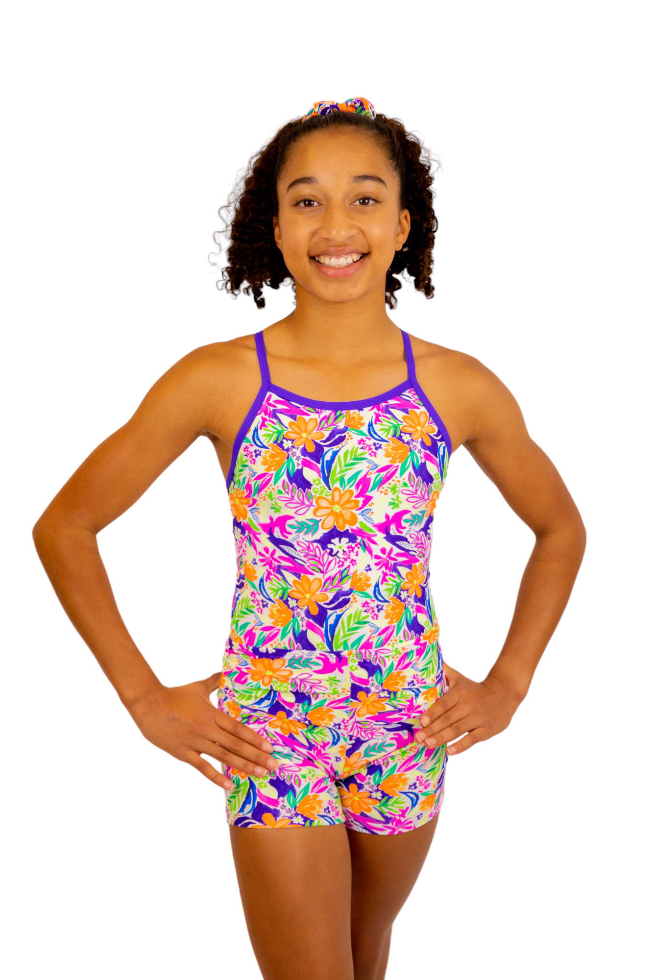 Bright Coloured Tropical Print One Piece Leotard or Swimsuit for Girls. Gymnastics Leotard, Girls Swimwear, Strappy Back, Racer Back, Tank Style, Thin Straps all Available. Fluorescent Purple, green, Yellow, Orange Flowers. Matching Scrunchie and Bike Shorts. B you Active, B you Leotards, B you Swimwear.