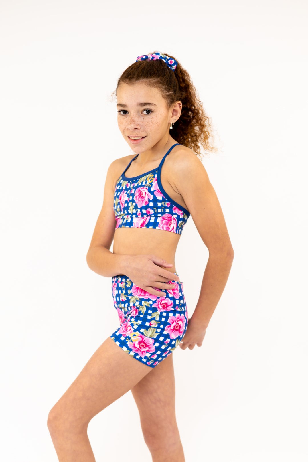 Navy Gingham Check Pink Flower Bike Shorts, Bike Pants with Gold Logo. Girls Activewear, Girls Gymnastics Wear, Girls Swimwear, Gymnastics Leotard, Dance Leotard, Booty Shorts, Crop top Set, Two Piece Set, Matching Leotard and Shorts, Bicycle Shorts, Gymnastics Australia, USA Gymnastics, Girls Leggings, Girls Tights, Girls Shorts. Coloured Bike Shorts. Gymnastics Shorts. Floral