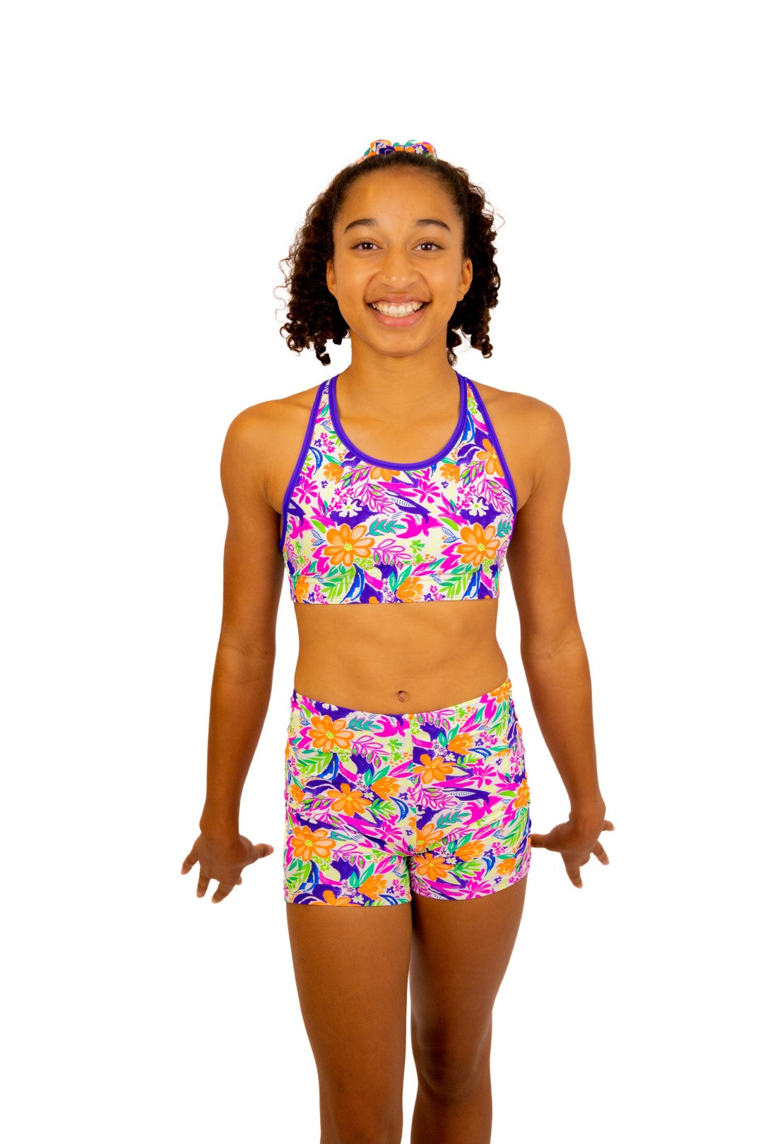 Tropical print Bike Pants or Bike Shorts. Fluorescent flowers, purple, orange, green. Gymnastics leotards, Two Piece Set, Crop Top set, Dancewear, Sports Bra, Gym Shorts, Booty Shorts. Activewear for Girls, Swimwear for Girls. B you Active, B you Leotards, B you Swimwear.