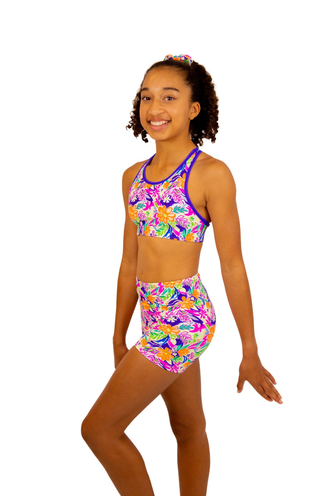 Tropical print Bike Pants or Bike Shorts. Fluorescent flowers, purple, orange, green. Gymnastics leotards, Two Piece Set, Crop Top set, Dancewear, Sports Bra, Gym Shorts, Booty Shorts. Activewear for Girls, Swimwear for Girls. B you Active, B you Leotards, B you Swimwear.