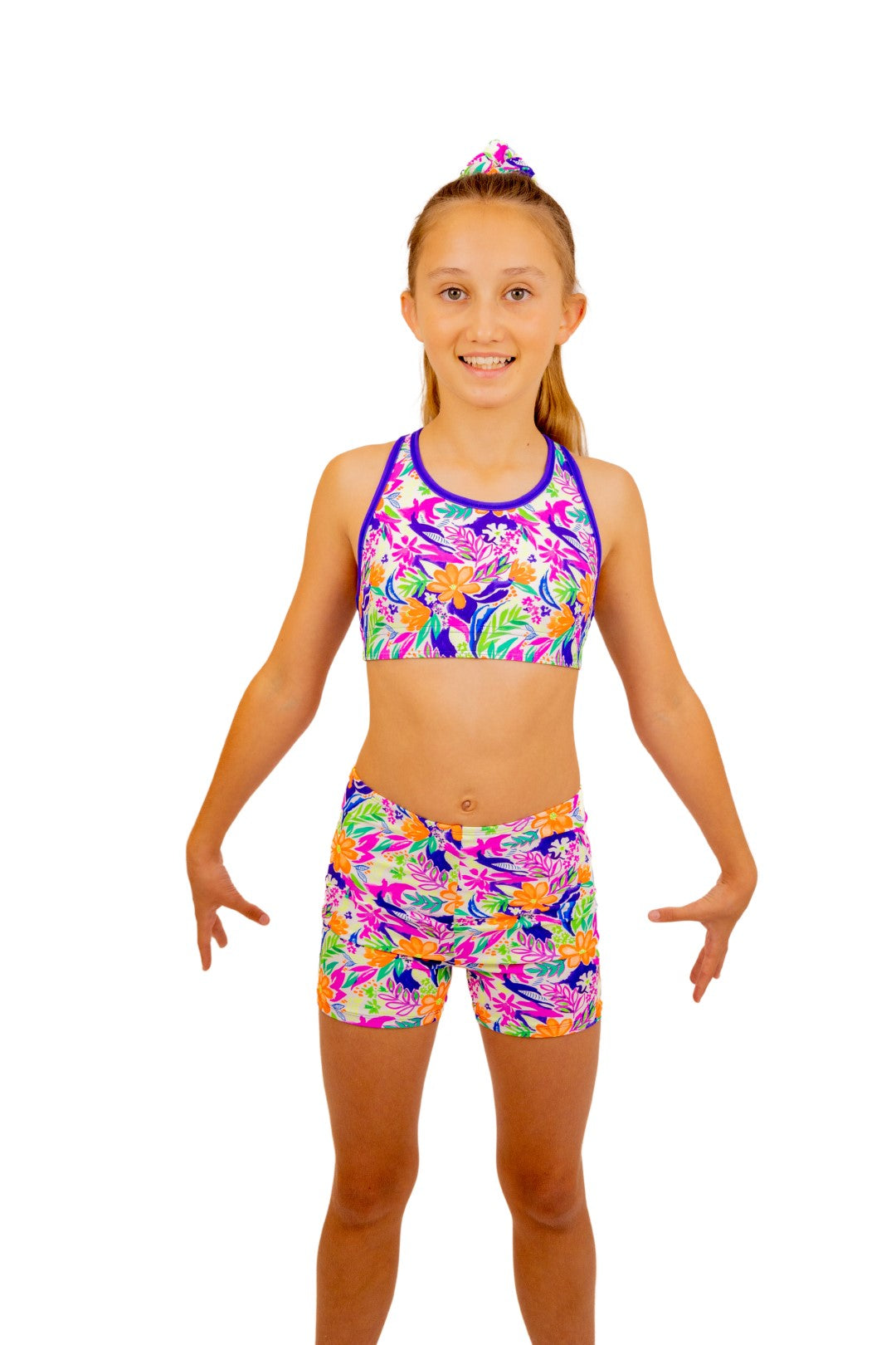 Tropical print Bike Pants or Bike Shorts. Fluorescent flowers, purple, orange, green. Gymnastics leotards, Two Piece Set, Crop Top set, Dancewear, Sports Bra, Gym Shorts, Booty Shorts. Activewear for Girls, Swimwear for Girls. B you Active, B you Leotards, B you Swimwear.