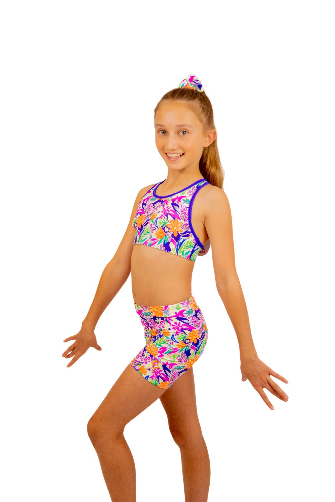 Tropical print Bike Pants or Bike Shorts. Fluorescent flowers, purple, orange, green. Gymnastics leotards, Two Piece Set, Crop Top set, Dancewear, Sports Bra, Gym Shorts, Booty Shorts. Activewear for Girls, Swimwear for Girls. B you Active, B you Leotards, B you Swimwear.
