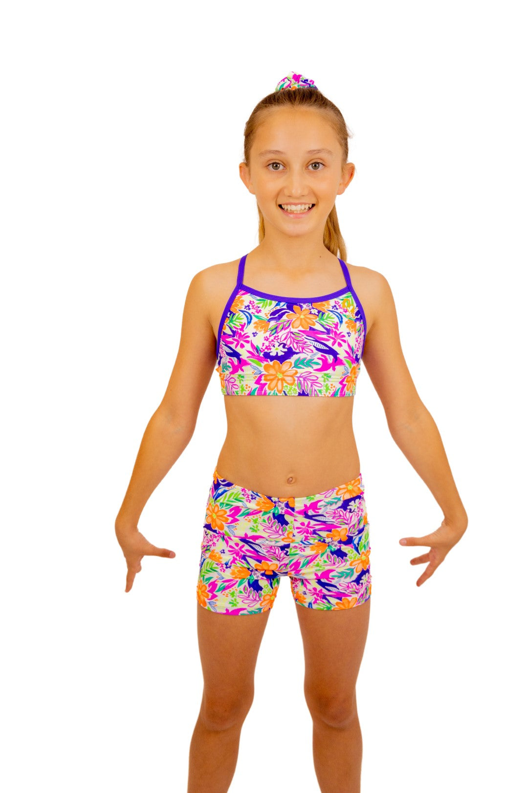 Tropical print Bike Pants or Bike Shorts. Fluorescent flowers, purple, orange, green. Gymnastics leotards, Two Piece Set, Crop Top set, Dancewear, Sports Bra, Gym Shorts, Booty Shorts. Activewear for Girls, Swimwear for Girls. B you Active, B you Leotards, B you Swimwear.