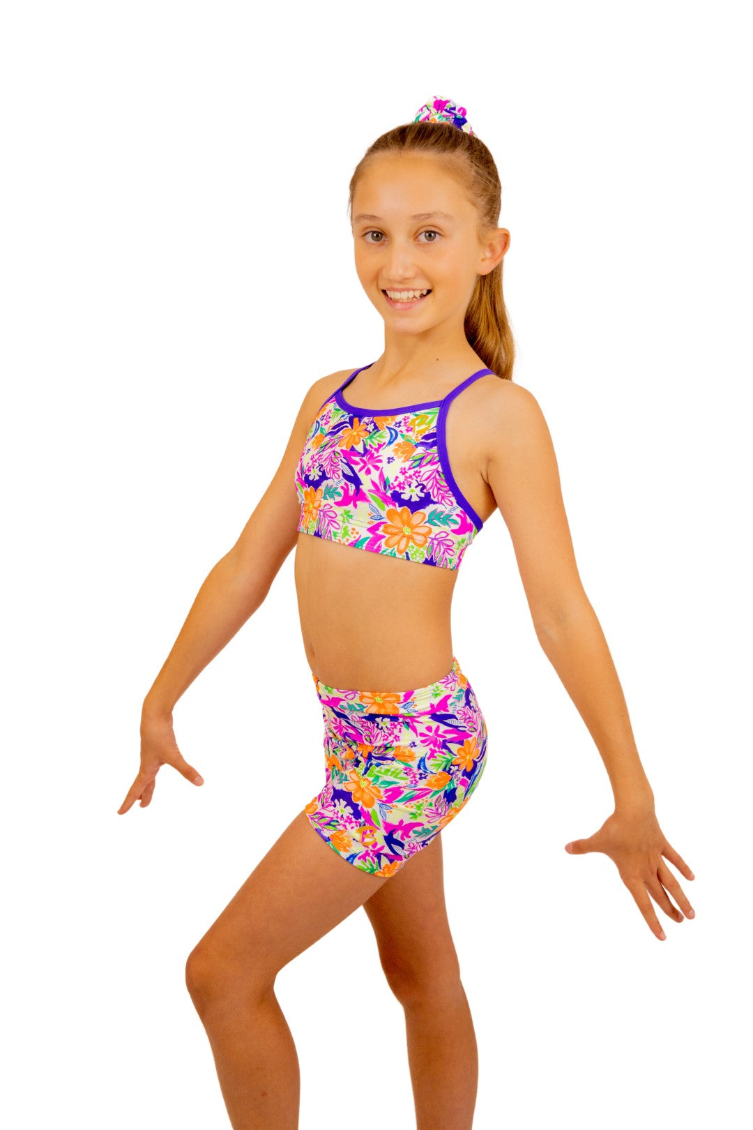 Tropical print Bike Pants or Bike Shorts. Fluorescent flowers, purple, orange, green. Gymnastics leotards, Two Piece Set, Crop Top set, Dancewear, Sports Bra, Gym Shorts, Booty Shorts. Activewear for Girls, Swimwear for Girls. B you Active, B you Leotards, B you Swimwear.